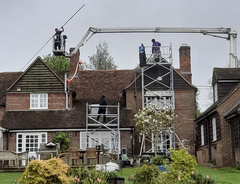 The Roof Moss Cleaners using cherry picker and scaffolding to clean roof safely and professionally in Redlynch, Wiltshire