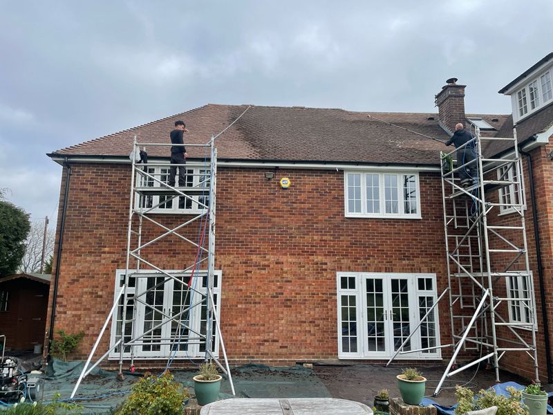 Roof cleaning carried out safely from scaffold towers by The Roof Moss Cleaners in Redlynch